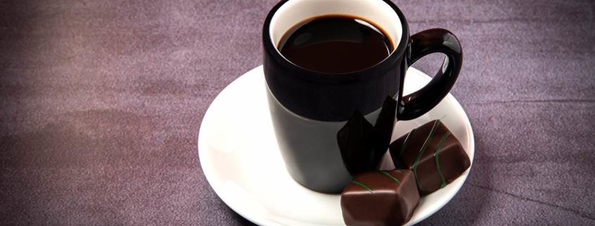 Photo of a cup of espresso with chocolate bonbons.