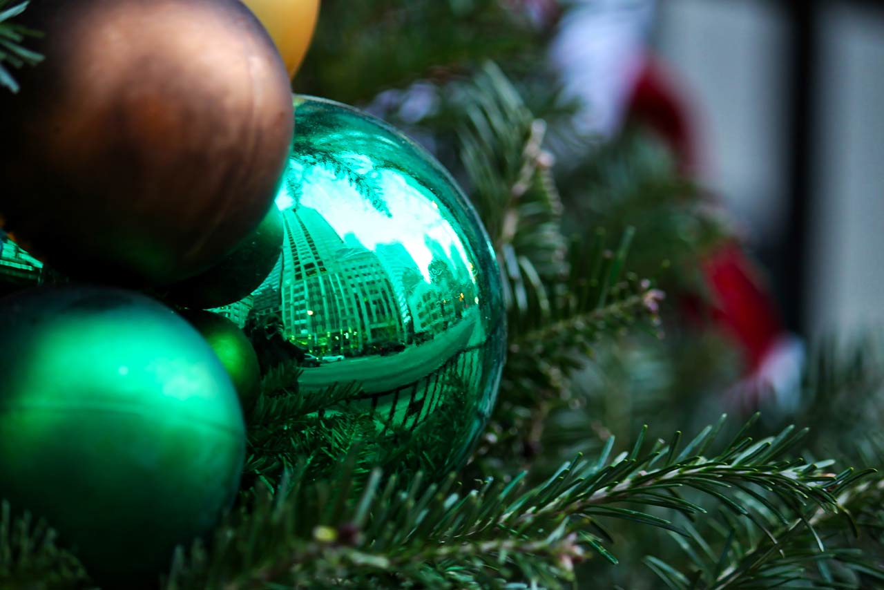 Photo of a reflection of Chicago cityscape shown in Christmas ornament in holiday decorated downtown