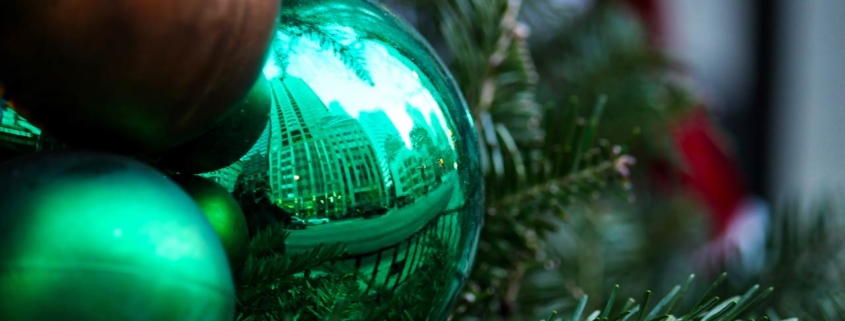 Photo of a reflection of Chicago cityscape shown in Christmas ornament in holiday decorated downtown