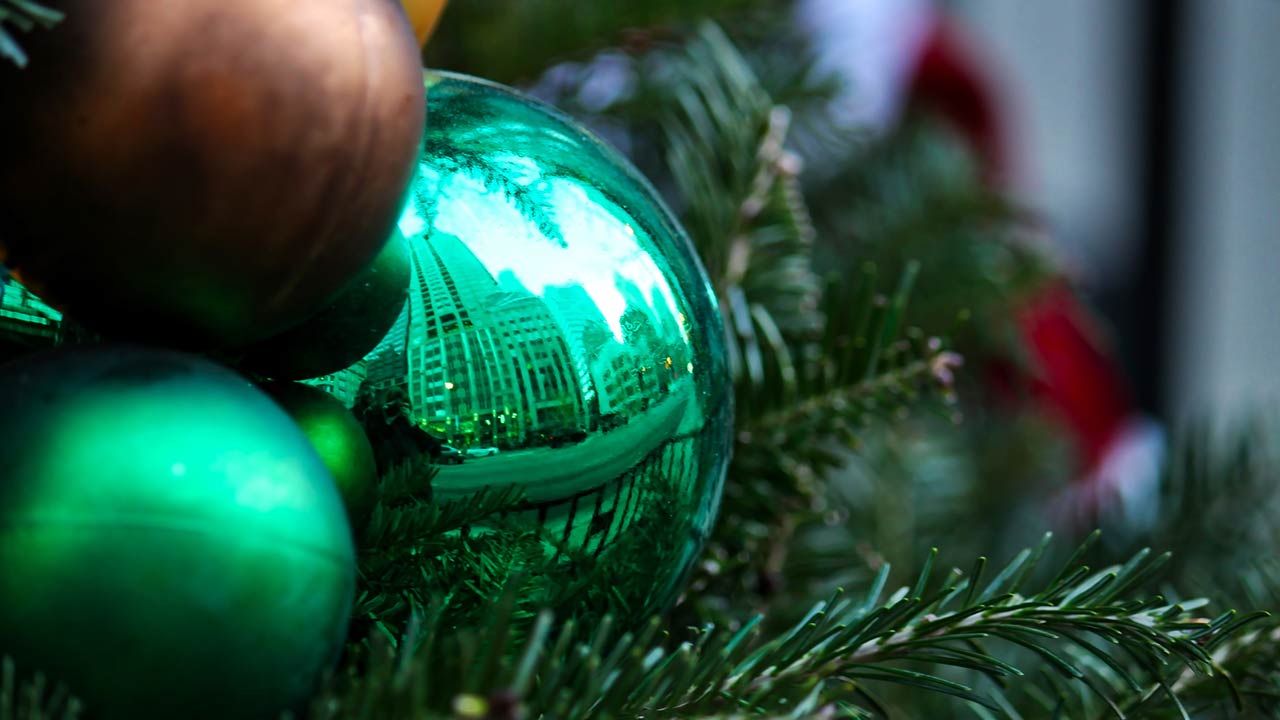 Photo of a reflection of Chicago cityscape shown in Christmas ornament in holiday decorated downtown