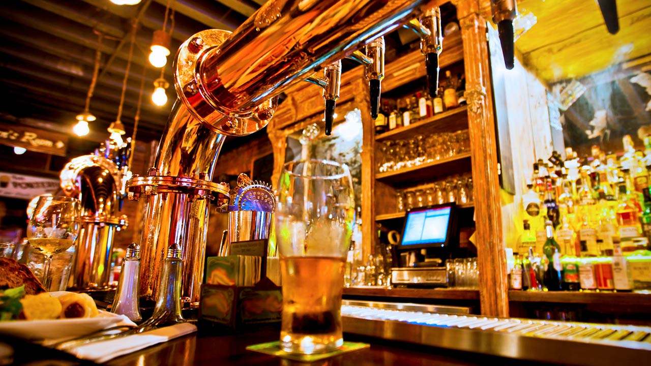 Photo of a pint of beer on a bar in a traditional style pub