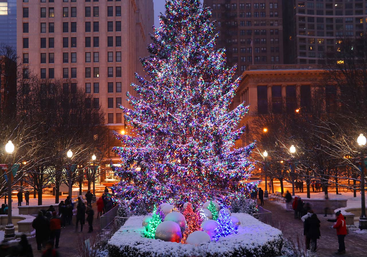 Photo of Chicago downtown cityscape with decorated Christmas tree glowing in the dark