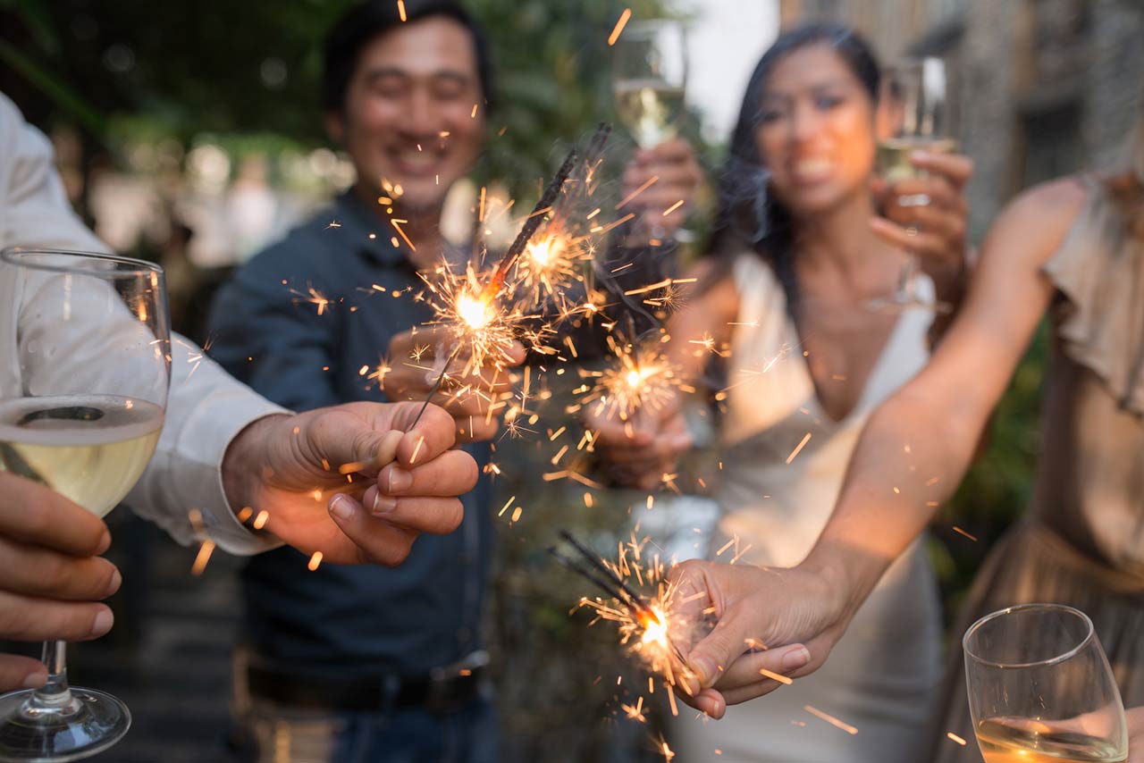 Photo of Haooy people at celebration holding glowing sparklers