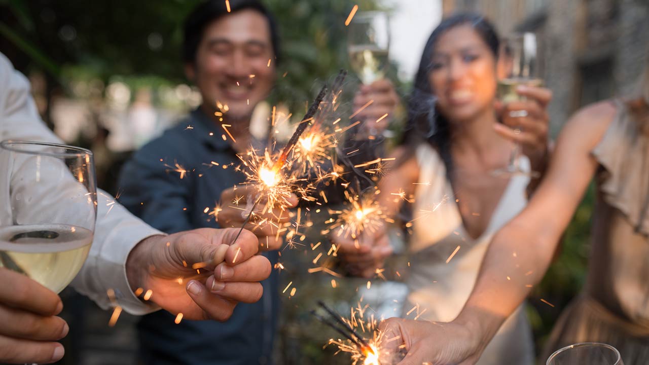 Photo of Haooy people at celebration holding glowing sparklers