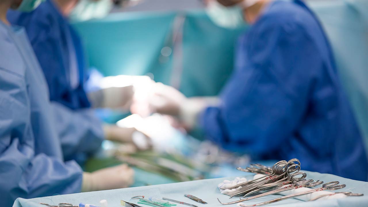 sterile surgical instruments on during the operation table amid the surgeons