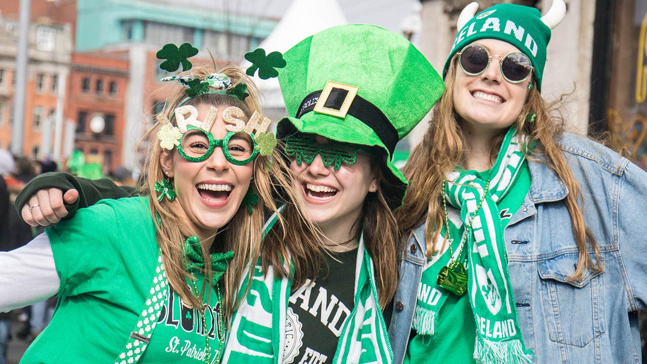 St. Patrick's Day, people with green hats and Irish flags in Dublin city