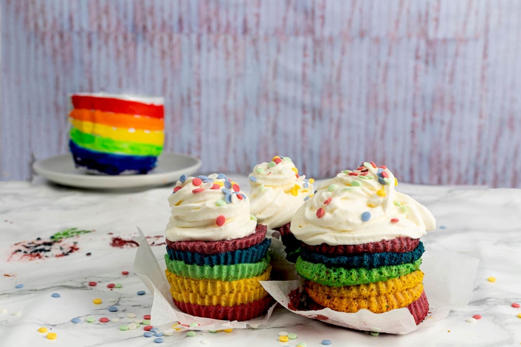 Cupcake or cake with cream and confetti in the colors of the rainbow. LGTBI+ pride celebration