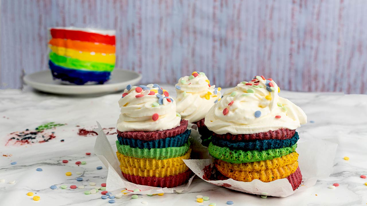 Cupcake or cake with cream and confetti in the colors of the rainbow. LGTBI+ pride celebration