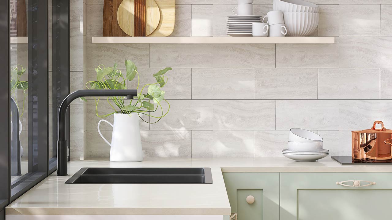 Minimal and cozy green kitchen with black quartz sink and sunlight