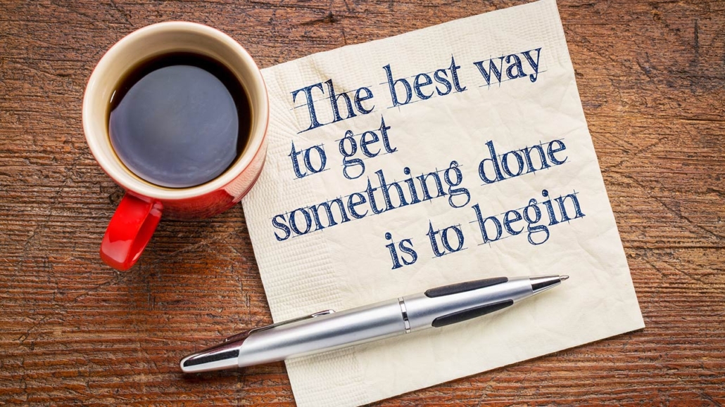 The best way to get something done is to begin - inspirational phrase on a napkin with a cup of coffee