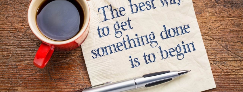 The best way to get something done is to begin - inspirational phrase on a napkin with a cup of coffee