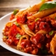 Pasta with meat, tomato sauce and vegetables on wooden background