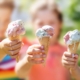 Group of children in the park eating cold ice cream