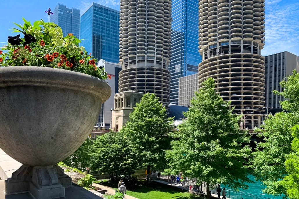 Summer in Chicago with flowers and greenery joining the architecture, Chicago River and diverse crowds