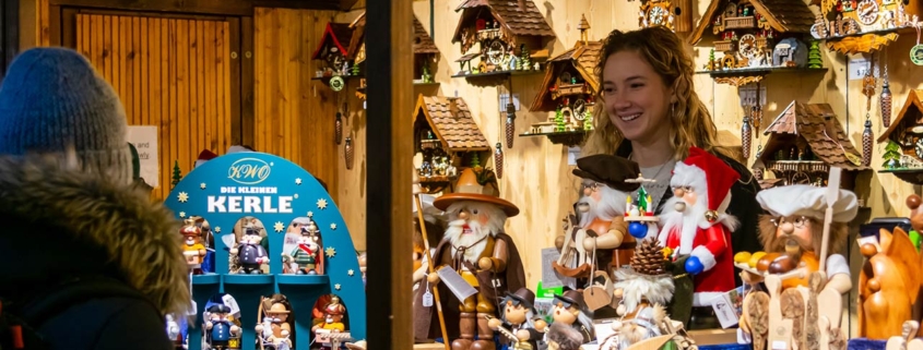 Shopkeeper selling Christmas-themed goods at the Christkindlmarket at the Daley Plaza in Chicago