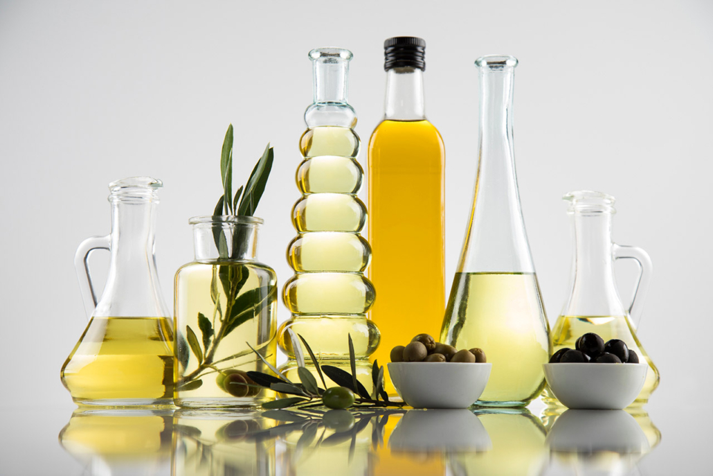 Bottles with organic cooking olive oil and olive branch