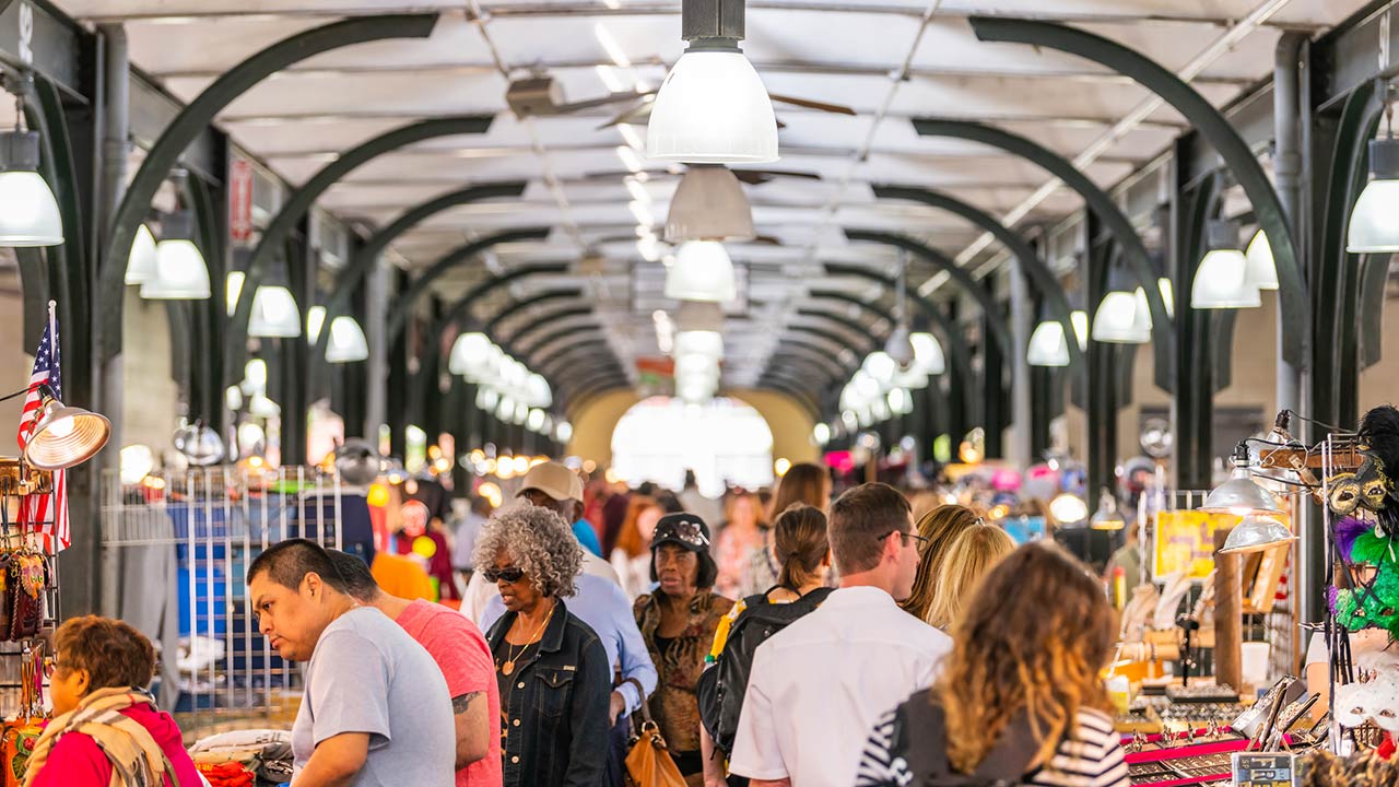Old town French Quarter covered food and flea market inside in Louisiana city and people shopping