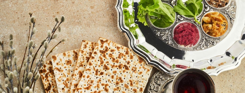 passover seder plate with traditional food on stone background