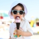 a child eating ice cream cone on the beach