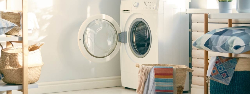 Interior of a real laundry room with a washing machine at home