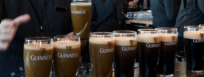 Guinness pints stock photo lined up on a bar serving area