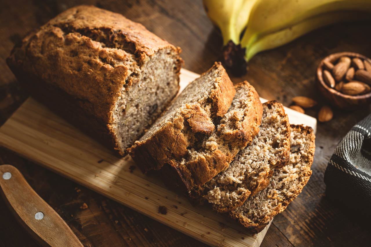 Banana Bread Loaf Sliced On Wooden Table