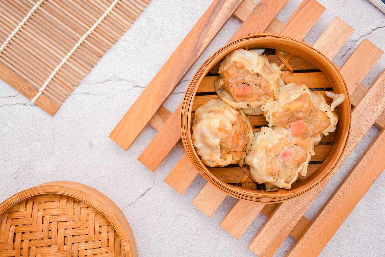 Fresh dimsum siu mai in a bamboo steamer