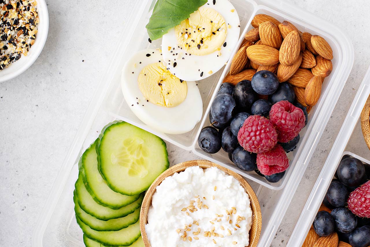 Lunch or snack box with high protein food, cottage cheese, nuts and eggs