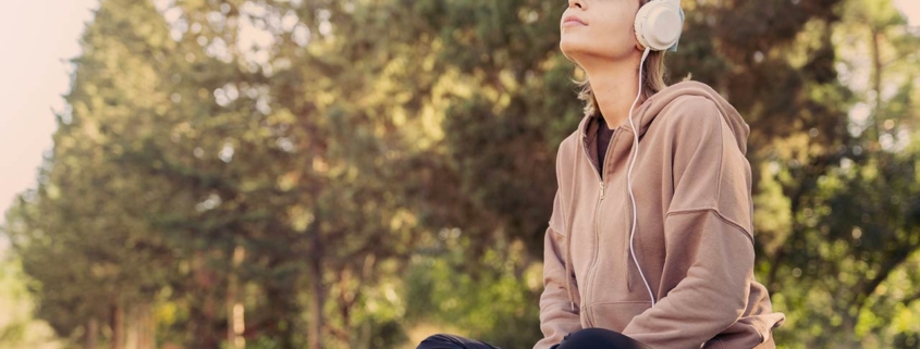 Woman listening to music with headphones in the nature