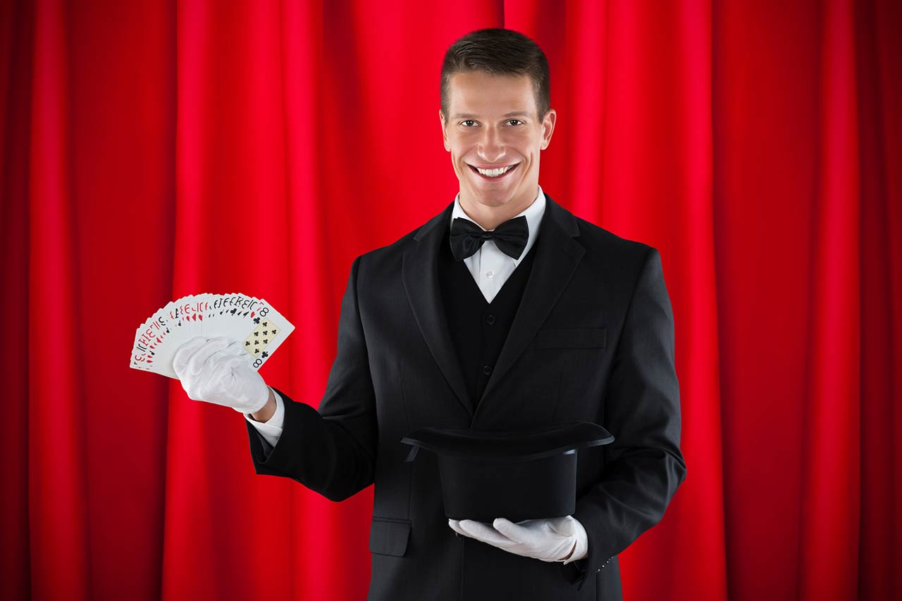Young Male Magician With Magic Cards And Hat