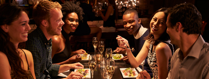 Group Of Friends Enjoying Meal In Restaurant stock photo