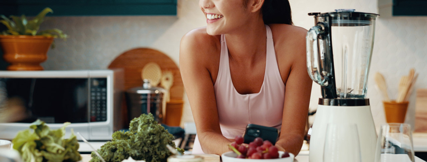 Phone, thinking and woman with smoothie in kitchen for health, wellness and diet breakfast