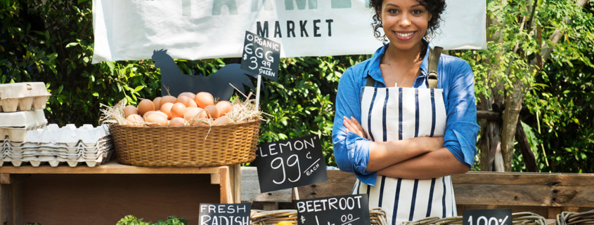 Greengrocer selling organic fresh agricultural product at farmer market stock photo