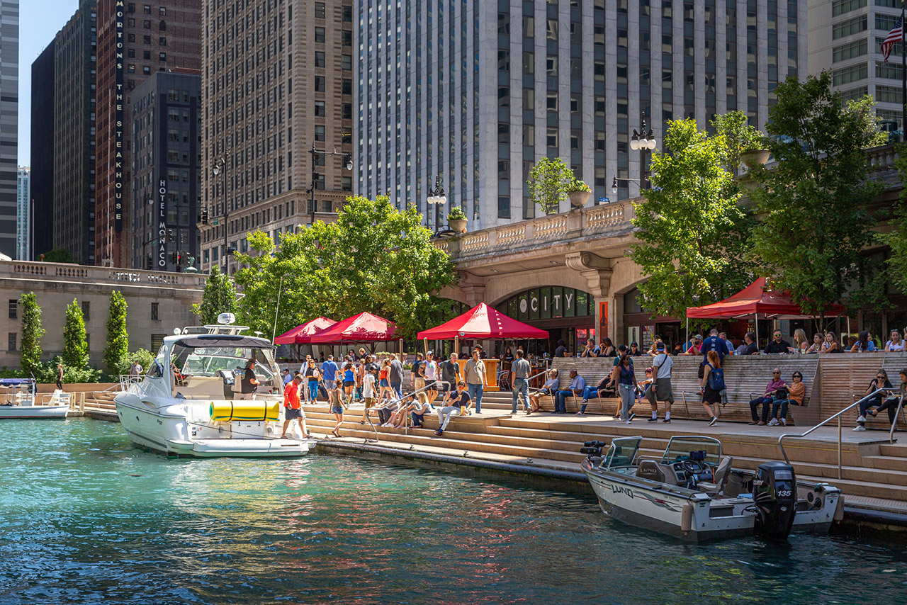 People walking along The Cove, a part of the Riverwalk public space on the Chicago River