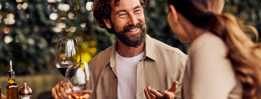 Happy Couple Enjoying Dinner Conversation at a Cozy Outdoor Restaurant stock photo